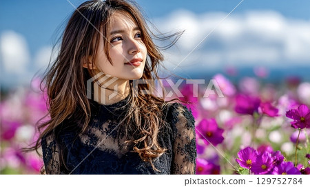 Autumn portrait of a young woman smiling in a cosmos field Autumn portrait of a young woman smiling in a cosmos field 129752784