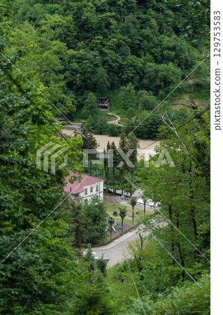A cable car in the mountains of Georgia. View of the city from a height A cable car in the mountains of Georgia. View of the city from a height 129753583