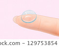 Hand holding contact lenses 129753854
