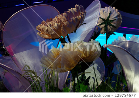Artificial flower composition with moving buds that open automatically, creating a stunning visual effect under soft lighting. The scene features intricate details and vibrant, surreal colors 129754677