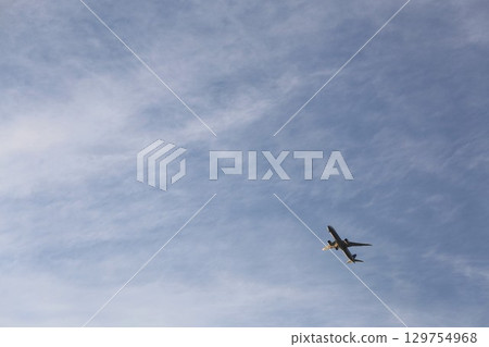 An airplane flying over the sky 129754968