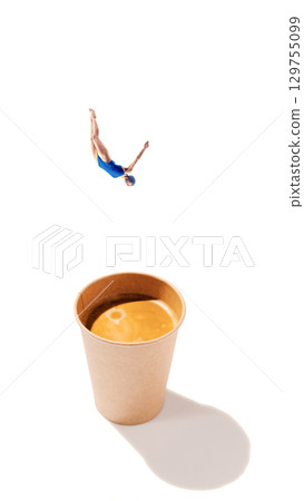 Creative composition. Diver in blue swimsuit falling into paper coffee cup on white background. Creative composition. Diver in blue swimsuit falling into paper coffee cup on white background. 129755099
