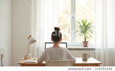 Person working in Scandinavian home office, back view 129755246