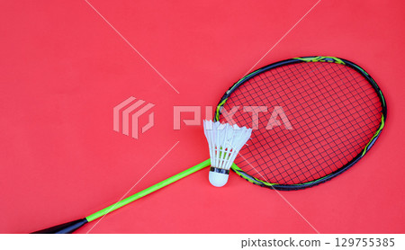 Shuttlecock and Racket on Red Background Shuttlecock and Racket on Red Background 129755385