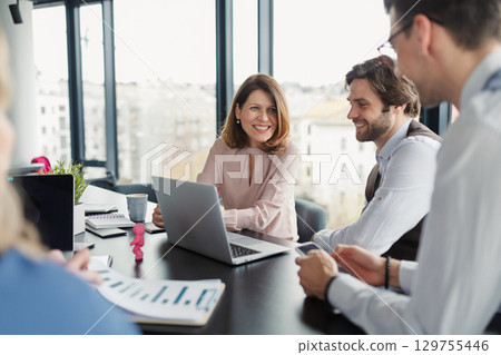 Group of coworkers discussing project strategy. Group of coworkers discussing project strategy. 129755446