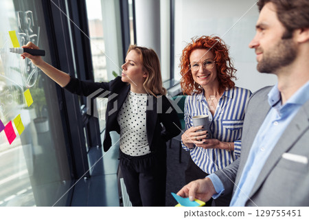 Business team reviewing project data, analysis financial situation. 129755451