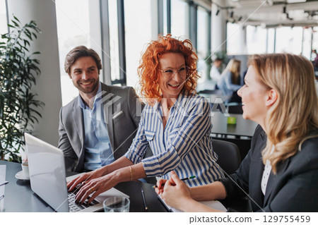 Group of coworkers discussing project strategy. Group of coworkers discussing project strategy. 129755459