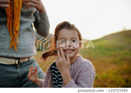 Portrait of beautiful young girl on walk in autumn nature, spending sunday outdoors. Portrait of beautiful young girl on walk in autumn nature, spending sunday outdoors. 129755495