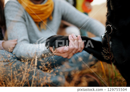 Family took dog on walk in autumn nature. Family took dog on walk in autumn nature. 129755504