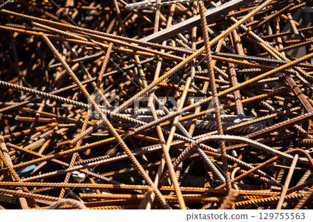 Rusty steel rebar scraps. Stack of rusty iron rods or bars Rusty steel rebar scraps. Stack of rusty iron rods or bars 129755563
