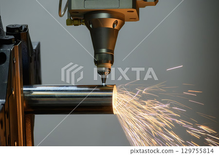 Close up scene the fiber laser cutting machine cut the stainless steel tube control by CNC program. Close up scene the fiber laser cutting machine cut the stainless steel tube control by CNC program. 129755814