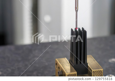 The CMM machine measuring the graphite electrode parts. The CMM machine measuring the graphite electrode parts. 129755818