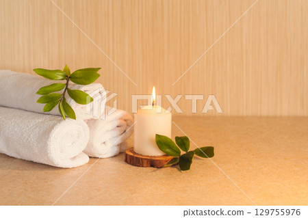 Spa, beauty and wellness background. Towel, leaf and candle 129755976