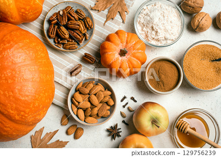Autumn fall baking background with pumpkins, apples and ingredients 129756239