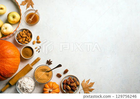Autumn fall baking background with pumpkins, apples, nuts, food ingredients Autumn fall baking background with pumpkins, apples, nuts, food ingredients 129756246