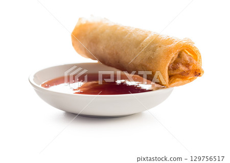 Fried spring rolls and sweet and sour sauce isolated on white background. Fried spring rolls and sweet and sour sauce isolated on white background. 129756517