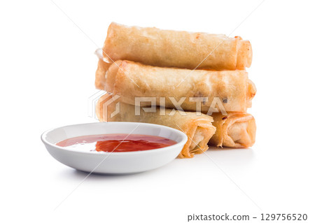 Fried spring rolls and sweet and sour sauce isolated on white background. Fried spring rolls and sweet and sour sauce isolated on white background. 129756520