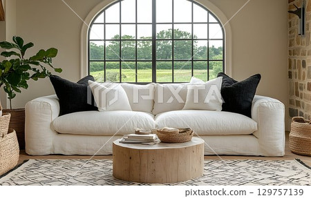 White linen sofa in bright room with large window view 129757139