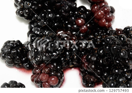 Close up of blackberries fruit on a white background Close up of blackberries fruit on a white background 129757493