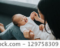 Mom playing with her baby 129758309