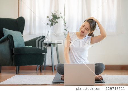 Woman stretching workout at home 129758311