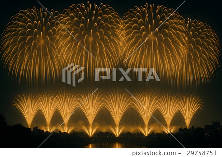 A spectacular sight of countless fan-shaped and large golden fireworks lighting up the riverside at night. A spectacular sight of countless fan-shaped and large golden fireworks lighting up the riverside at night. 129758751