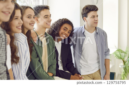 Group of happy cheerful teenage multiethnic boys and girls having fun at school event Group of happy cheerful teenage multiethnic boys and girls having fun at school event 129758795
