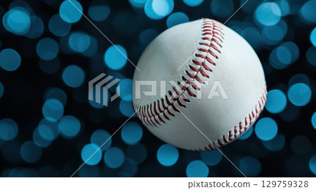 baseball mid flight against textured blue background creates dynamic scene 129759328