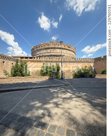 Majestic Castel Sant'Angelo in Rome, Italy. An ancient cylindrical fortress, built with brick, features high crenellated walls 129760591