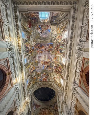 Breathtaking baroque fresco on the ceiling of the Sant'Ignazio basilica, depicting the Apotheosis of Saint Ignatius, Rome, Italy. Illusionistic painting ascending towards a divine light 129760600