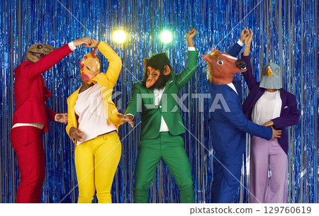 Happy trendy people in colorful party suits and animal masks dancing in nightclub 129760619
