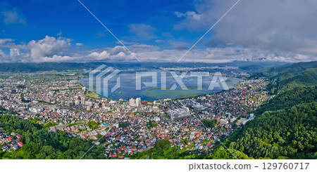 Summer scenery of Lake Suwa surrounded by lush green mountains and the city Summer scenery of Lake Suwa surrounded by lush green mountains and the city 129760717