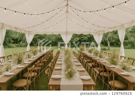 Elegant outdoor wedding tent in a garden setting with tables decorated for a beautiful celebration. concept of elegant wedding reception, nature, romantic decor 129760928
