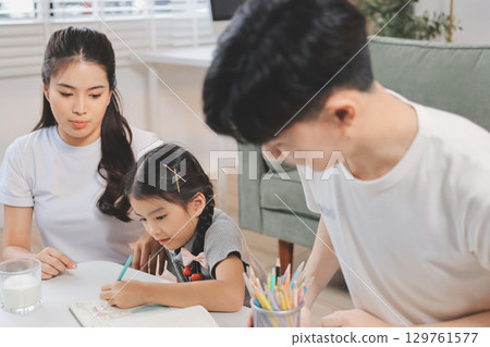 Family spends their free time together Family spends their free time together 129761577