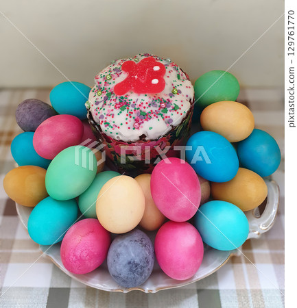 A white plate with a cake on top and a bunch of eggs underneath A white plate with a cake on top and a bunch of eggs underneath 129761770