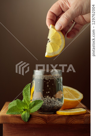 Diet vegan cocktail with chia seeds, lemon, and mint. 129762004