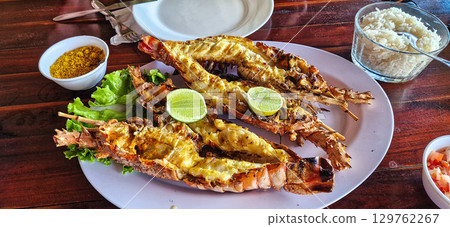Traditional lobster meal on the banks of the Torta Lagoon, Tatajuba Beach at Jijoca de Jericoacoara, Ceara in Brazil Traditional lobster meal on the banks of the Torta Lagoon, Tatajuba Beach at Jijoca de Jericoacoara, Ceara in Brazil 129762267