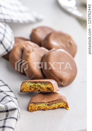 Dubai style chocolate cookies on white table. Dubai style chocolate cookies on white table. 129762440