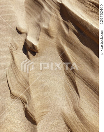 Wind Sculpted Sand Dunes Texture in Desert - Abstract Natural Pattern Wind Sculpted Sand Dunes Texture in Desert - Abstract Natural Pattern 129762460