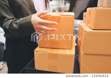 Portrait of Starting small businesses SME owners, two Asian woman check online orders Selling products working with boxs freelance work at home office, sme business online small medium enterprise Portrait of Starting small businesses SME owners, two Asian woman check online orders Selling products working with boxs freelance work at home office, sme business online small medium enterprise 129762614