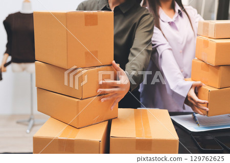 Portrait of Starting small businesses SME owners, two Asian woman check online orders Selling products working with boxs freelance work at home office, sme business online small medium enterprise Portrait of Starting small businesses SME owners, two Asian woman check online orders Selling products working with boxs freelance work at home office, sme business online small medium enterprise 129762625