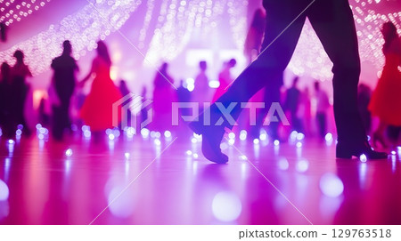Dancing People in a Glowing Ballroom with Formal Attire, blurred view. 129763518