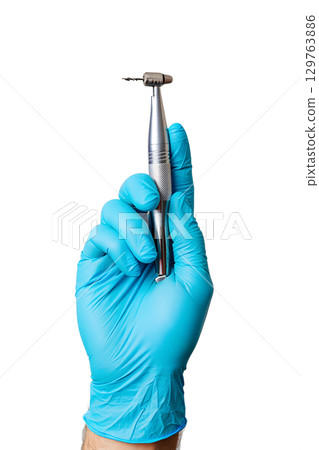 Dentist's gloved hand holding dental drill, oral surgery tool isolated on transparent background 129763886