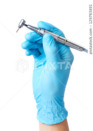 Close-up of surgical glove gripping dental handpiece, professional dentistry equipment isolated 129763891
