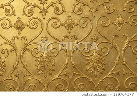 Intricate Golden Wall Design Showcasing Artistic Craftsmanship in Detail 129764177