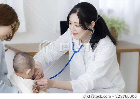 Baby receiving medical examination Baby receiving medical examination 129766306