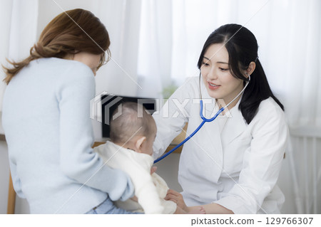 Baby receiving medical examination Baby receiving medical examination 129766307