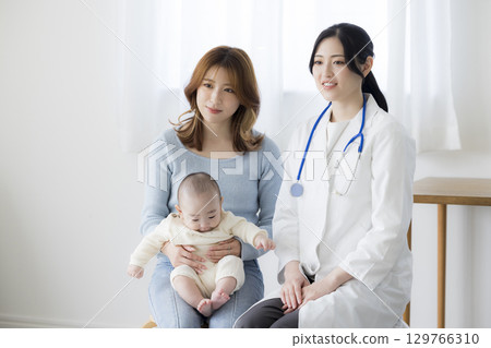 Baby receiving medical examination 129766310