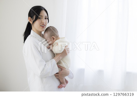 Baby receiving medical examination Baby receiving medical examination 129766319