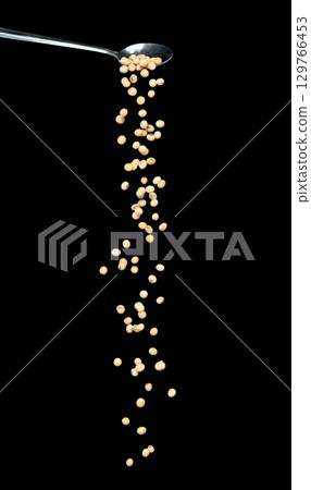 Soy Bean fall, yellow grain beans explode abstract cloud fly from silver spoon. Beautiful complete seed pea soy bean, food object design. Selective focus freeze shot black background isolated 129766453